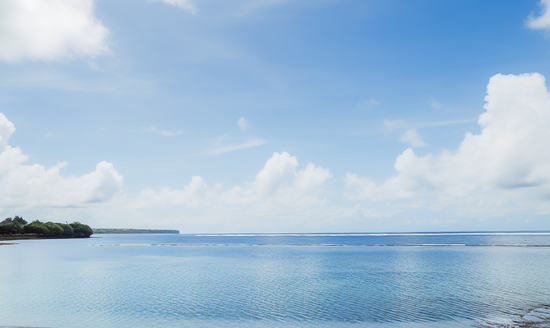 A peaceful scene of bali's beaches with calm waters and clear sky