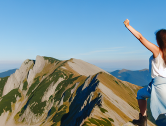 A woman standing on a mountain peak, demonstrating independence and thirst for adventure